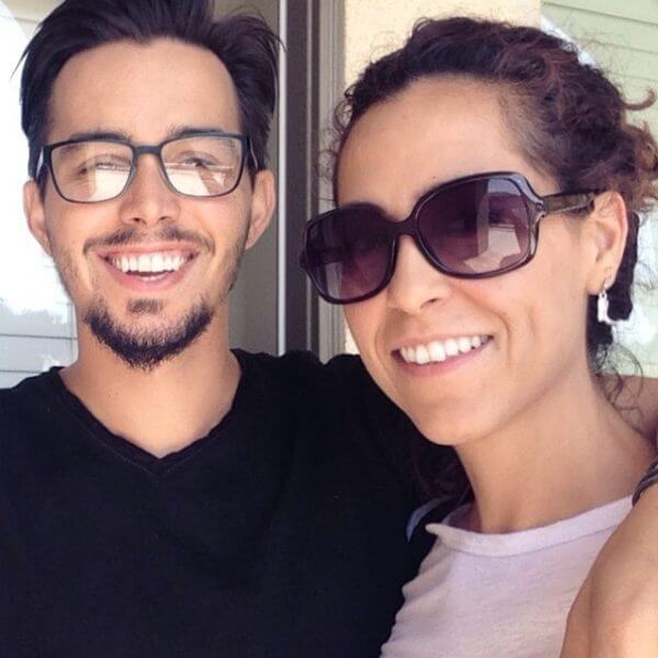 Blake Lewis poses with his arm around Amanda Zamora-Lewis. Both are smiling at the camera.