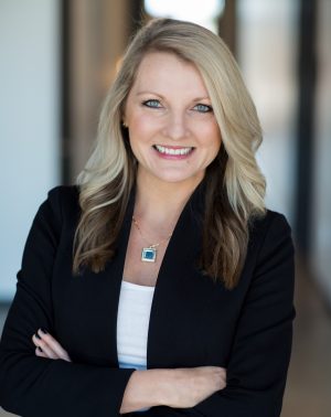 Shannon Williams, poses with her arms crossed, wearing a black blazer