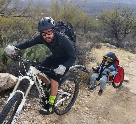 Jerome Lacote mountain biking with a child