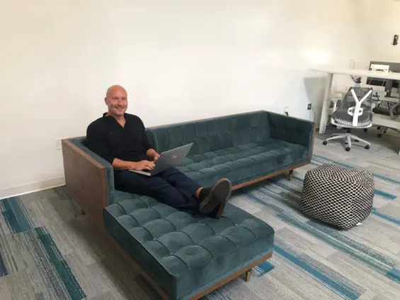 Scott Boring on a couch with a laptop