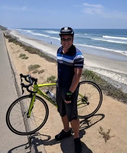 Todd Anderson with road bike at the beach