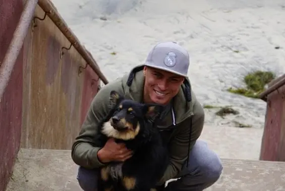 Victor Tapia with a dog at the beach