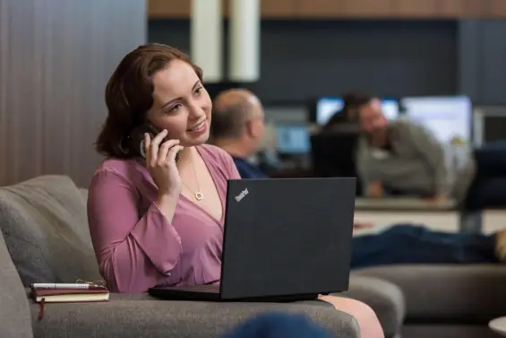 Woman takes a client call in a co working space