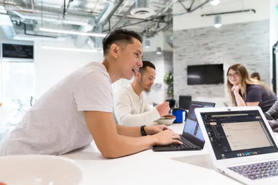 Team members collaborate at a meeting